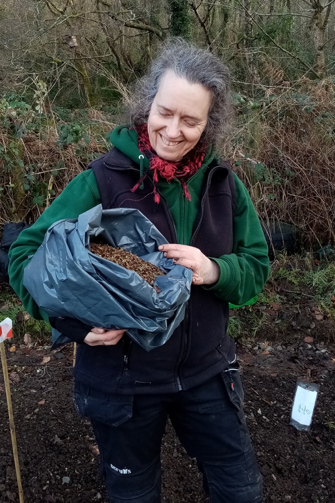 Ann Owen with bag of dried alder for use as fetiliser